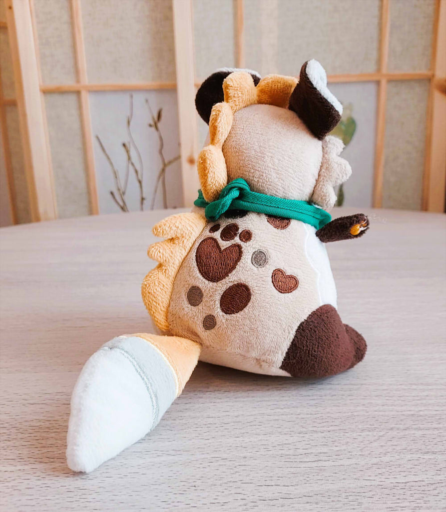 Back view of BeanBuds beanie plush of ChocoChip the spotted hyena wearing a green bandana