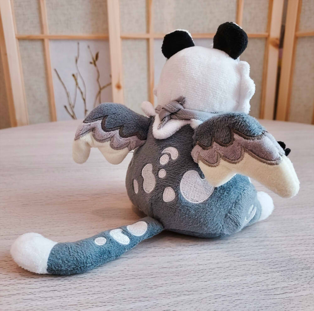 Back view of BeanBuds beanie plush of Sesame the grey and white gryphon