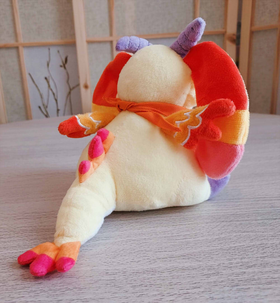 Back view of BeanBuds beanie plush of Charmy the yellow and orange dragon