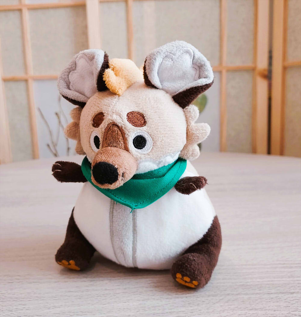 BeanBuds beanie plush of ChocoChip the spotted hyena wearing a green bandana