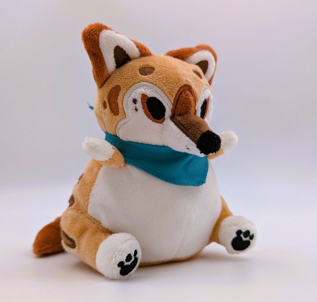 Plush toy thylacine with a blue bandana on a white background