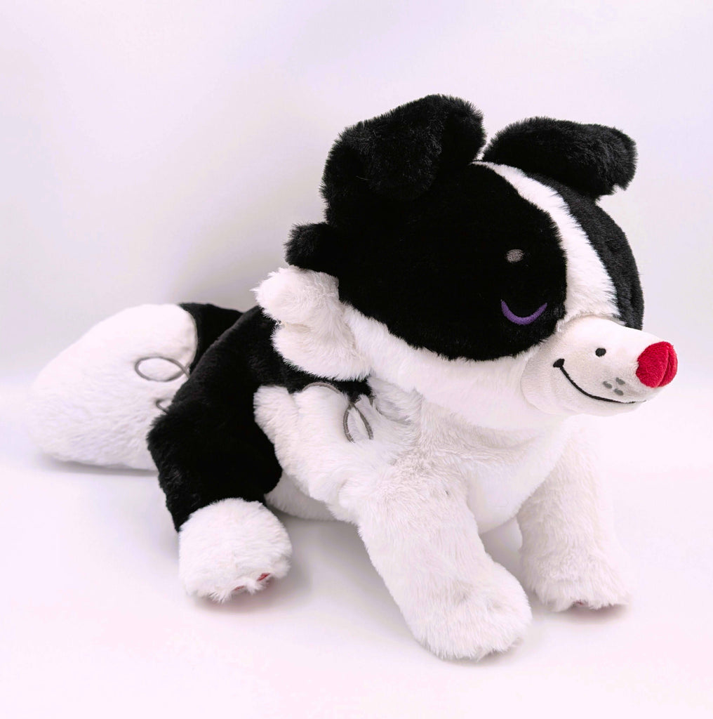 Black and white border collie plush with purple eyes and red nose