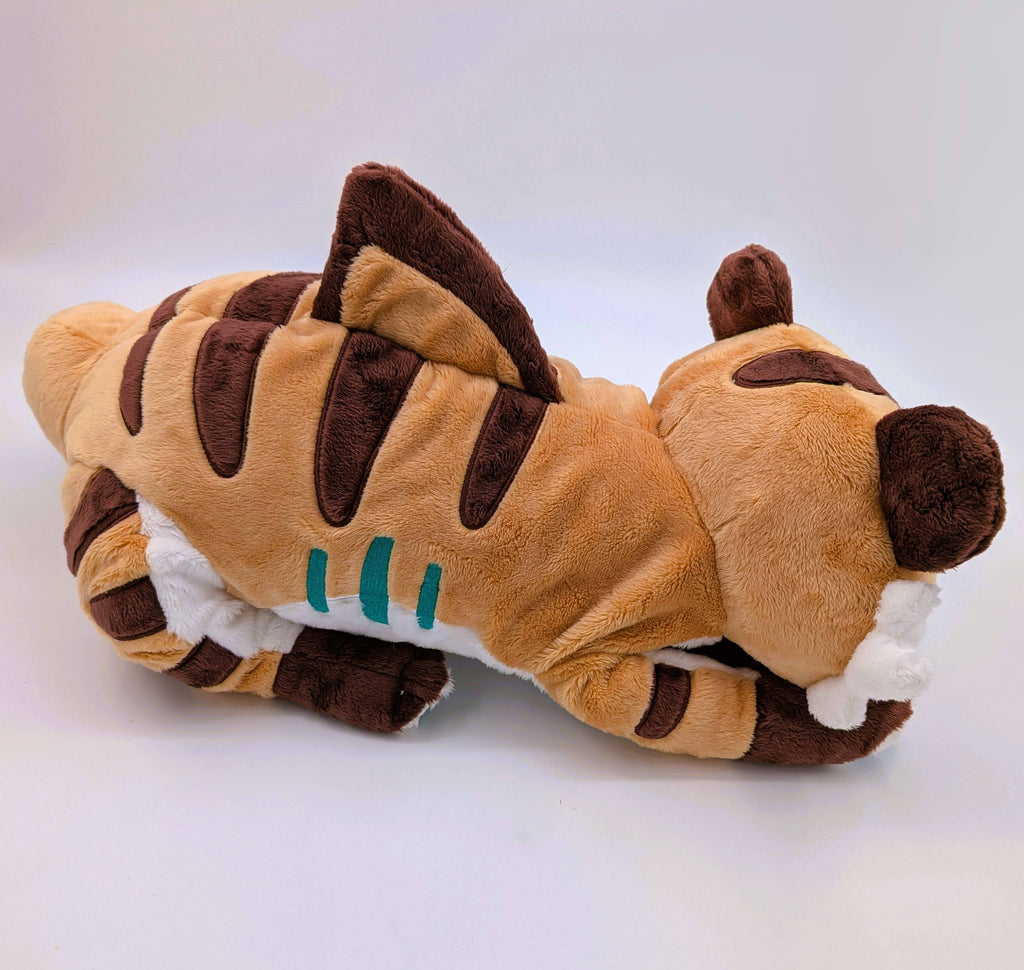 Side view of a plush of Cornflakes the Tiger and Shark hybrid