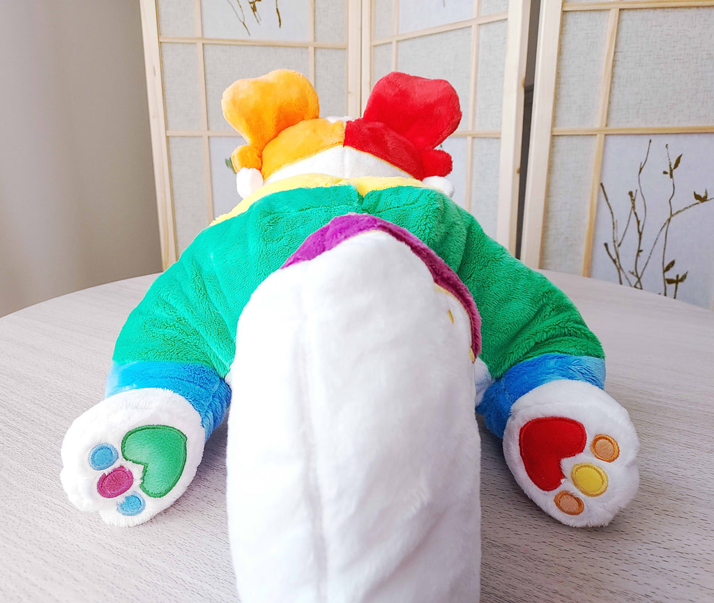 Back view of weighted plush pillow of Jellybeans the rainbow pride border collie lying down