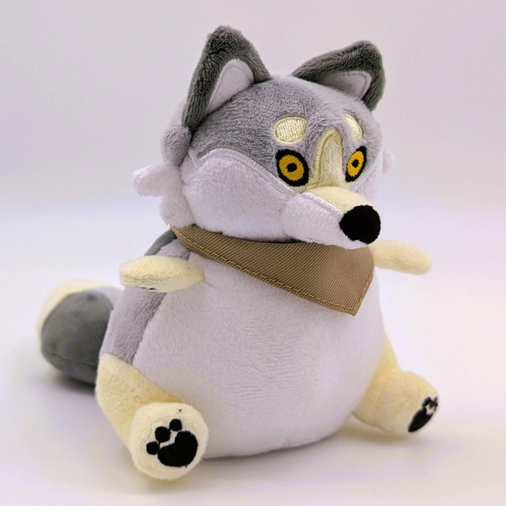 Plush toy wolf with a bandana on a white background