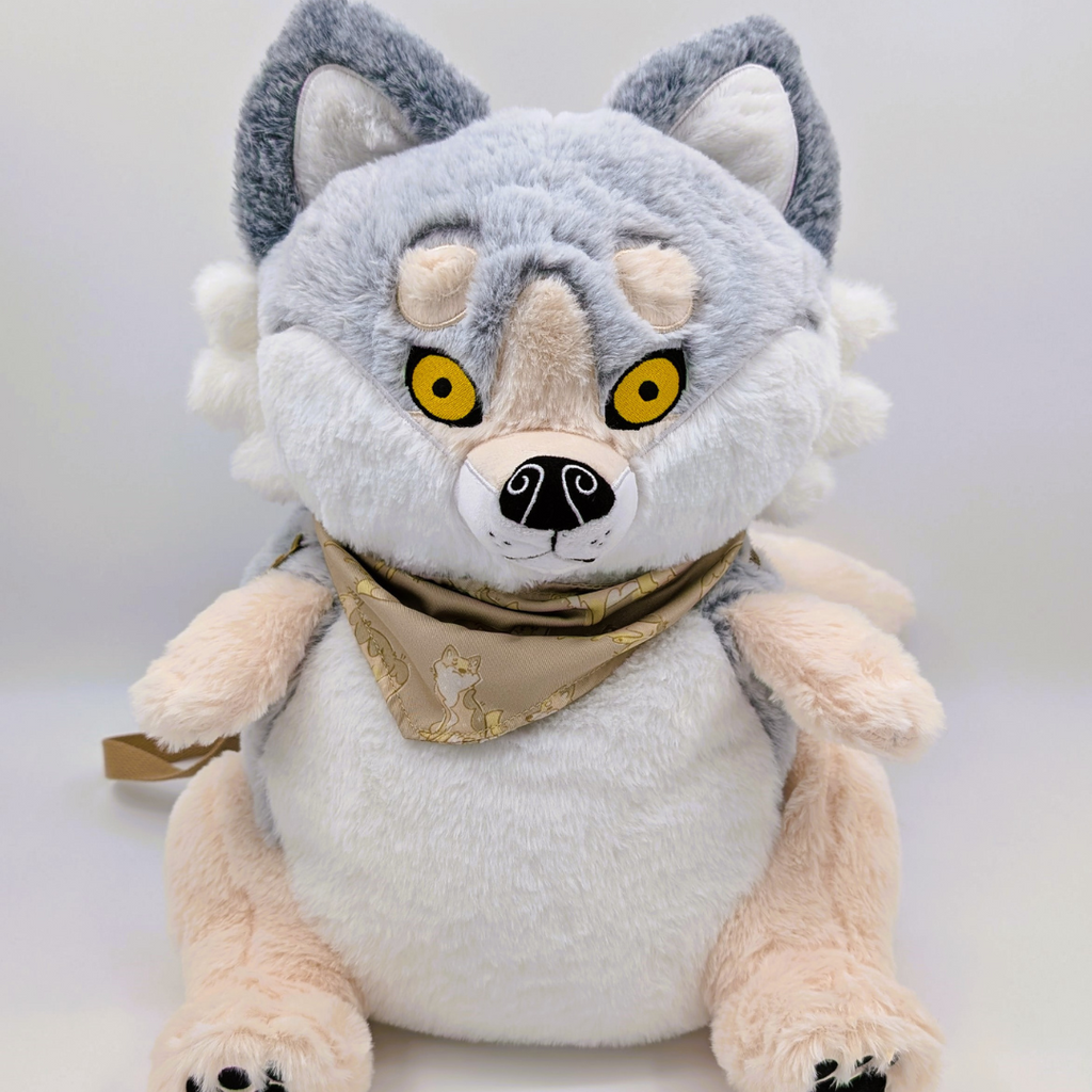 Plush backpack of a wolf with yellow eyes and a beige bandana on a white background