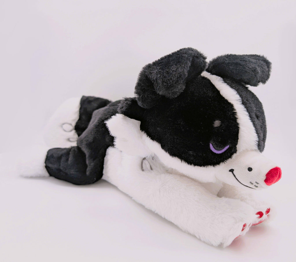 Black and white border collie plush with purple eyes and red nose