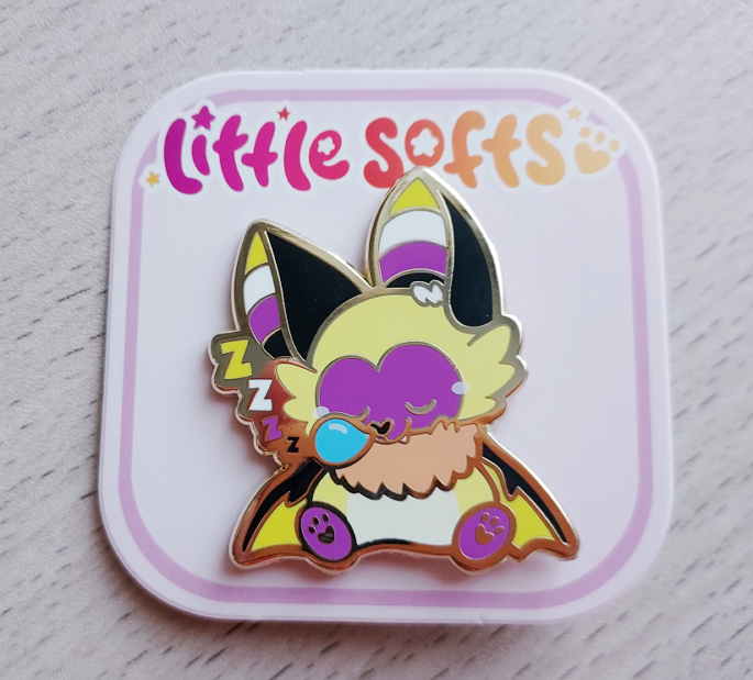 Enamel pin of butter the yellow, purple, and white bat. He is asleep with a bubble coming out of his nose