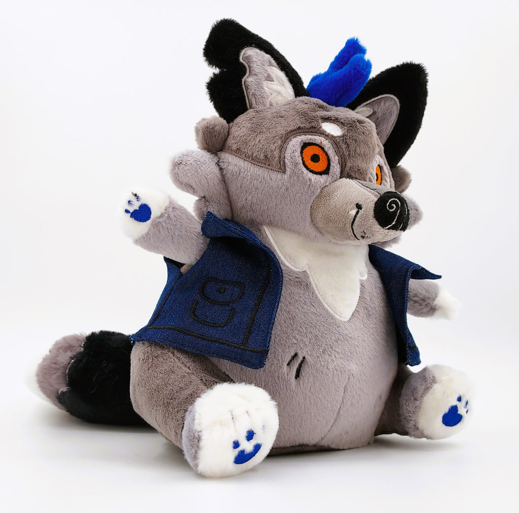 Three-quarters view of a plush toy of Wolfgang the werewolf with blue hair and a blue denim vest 