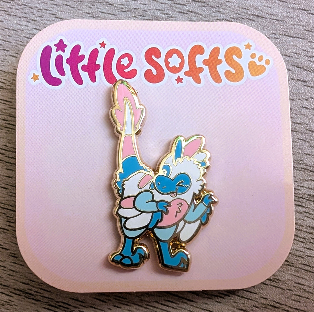 Enamel pin of Cotton Candy the blue, pink, and white utahraptor