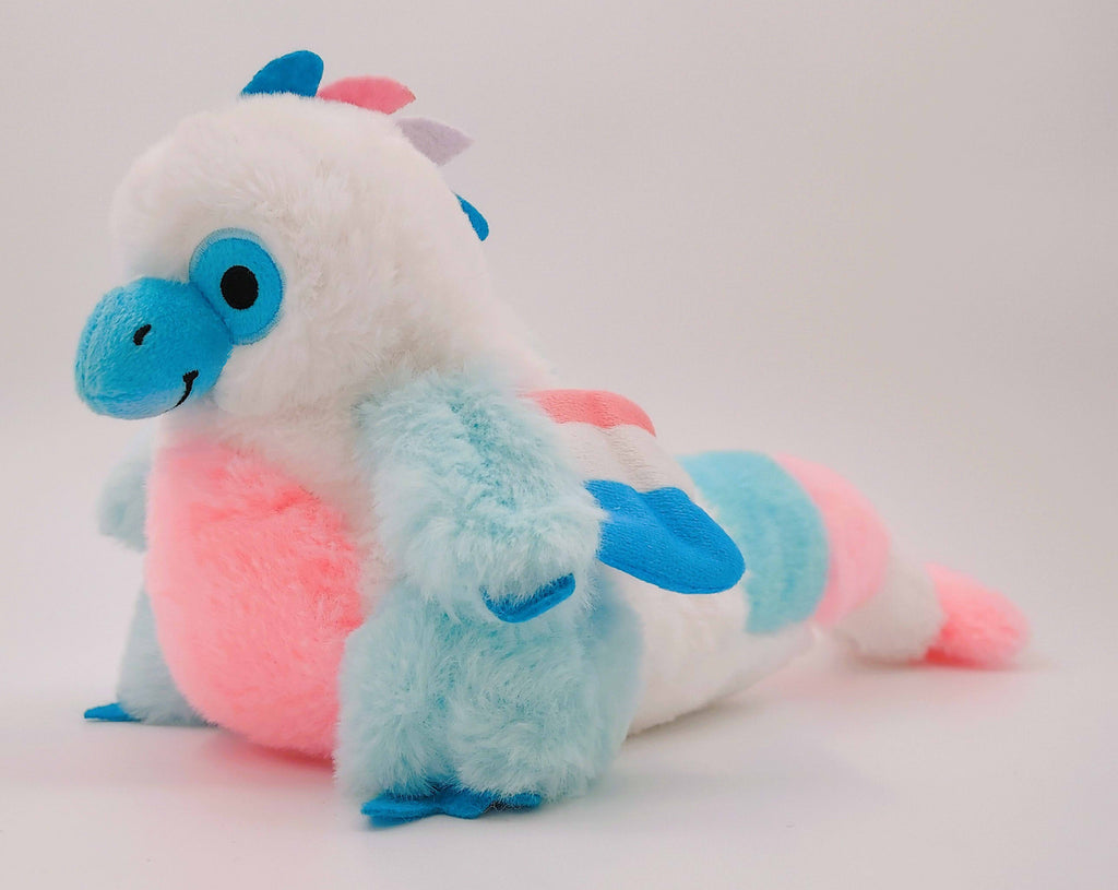 Plush toy of Cotton Candy the blue, pink, and white utahraptor