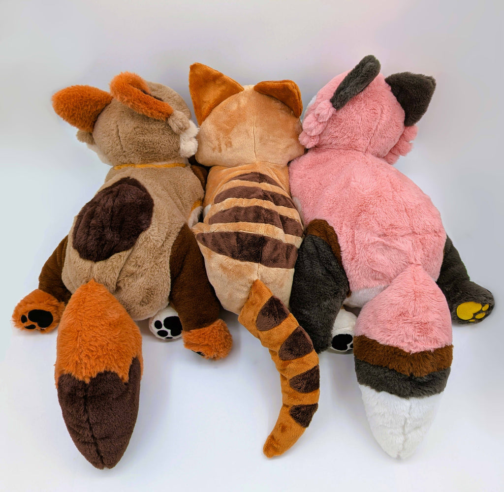 Back view of plush toys of Litha the Coyote Pup, Hobart the Thylacine, and Chiffon the Fox