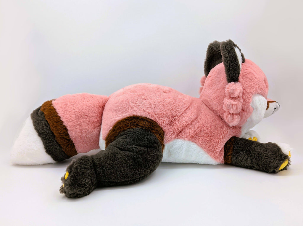 Side view of plush toy of Chiffon the red fox