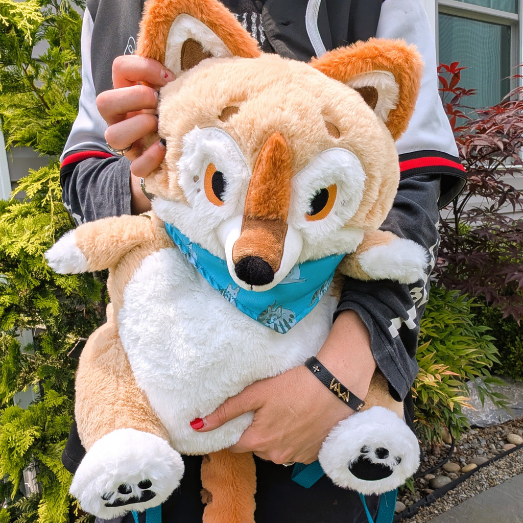 Person holding a plush backpack of a thylacine