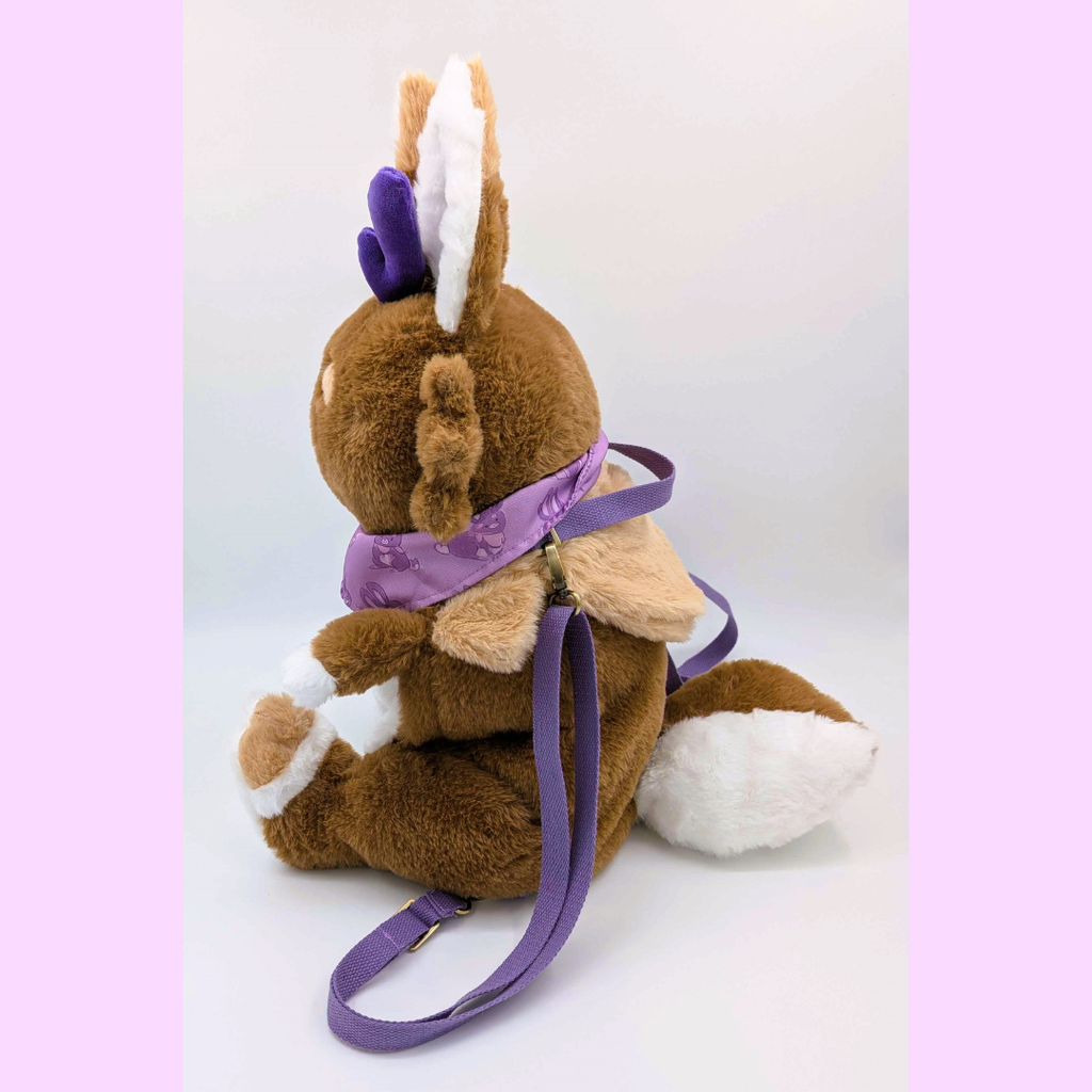 Side view of a plush backpack of the jackalope