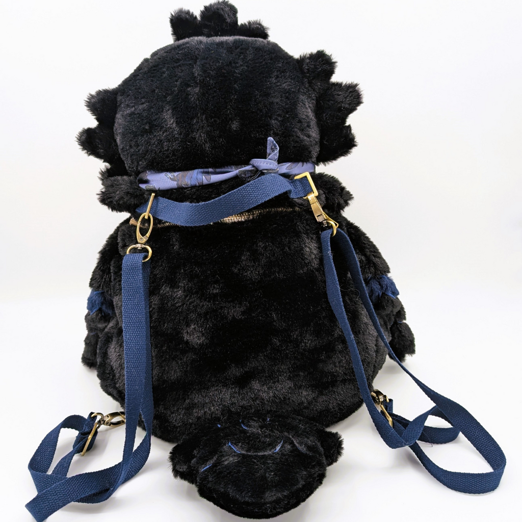 Back view of a plush backpack of a raven