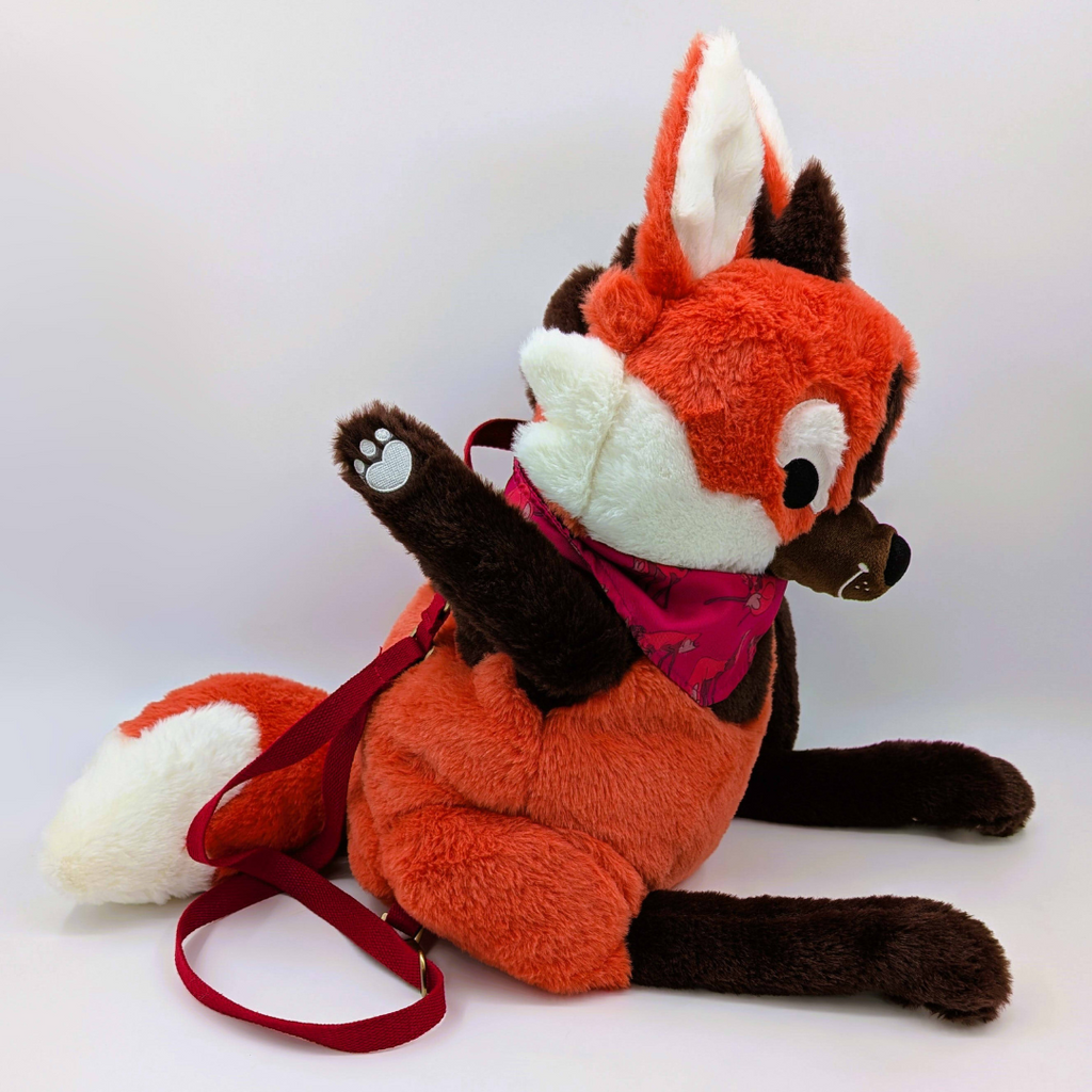 Side view of a plush backpack of a maned wofl