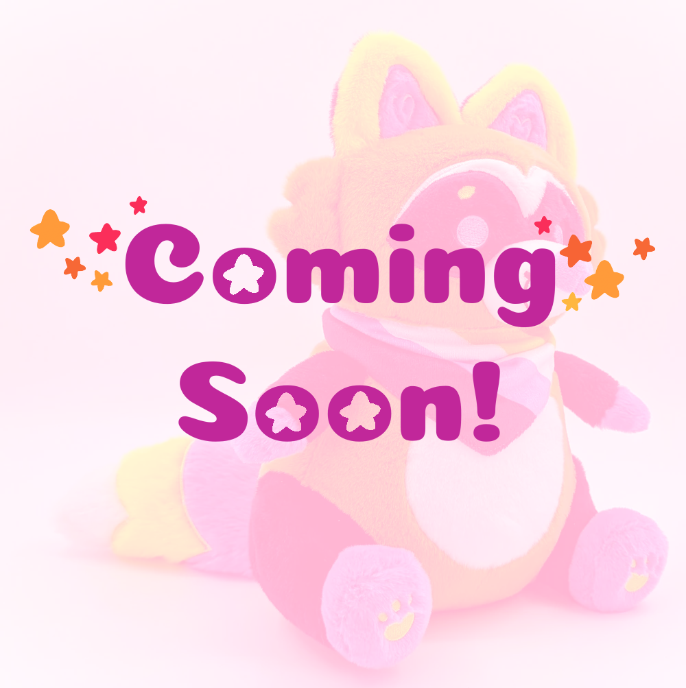 Plush toy of Mango the orange, blue, yellow raccoon with coming soon text