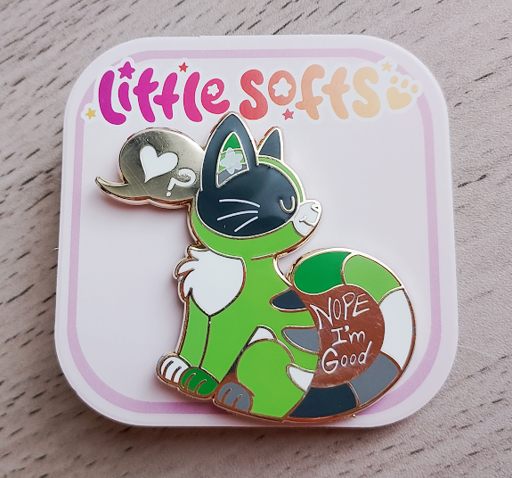 Enamel pin of Matcha the green alley cat with text that says "Nope I'm good"