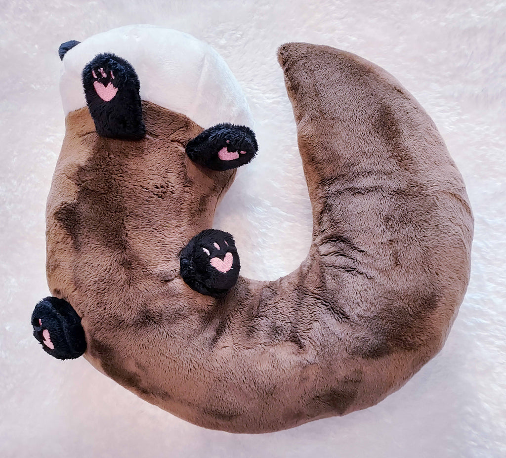 Bottom view of Nuzzle Noodles plush neck pillow of Oatmeal the otter 