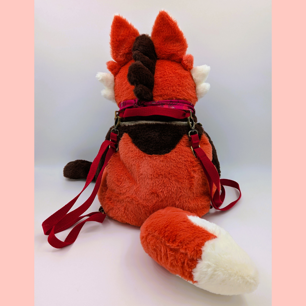 Back view of a plush backpack of a maned wolf