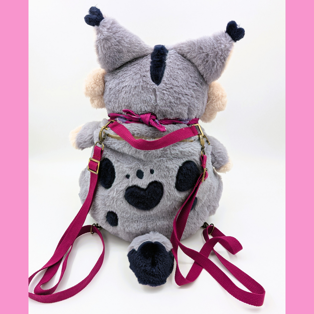 Back view of a plush backpack of a lynx