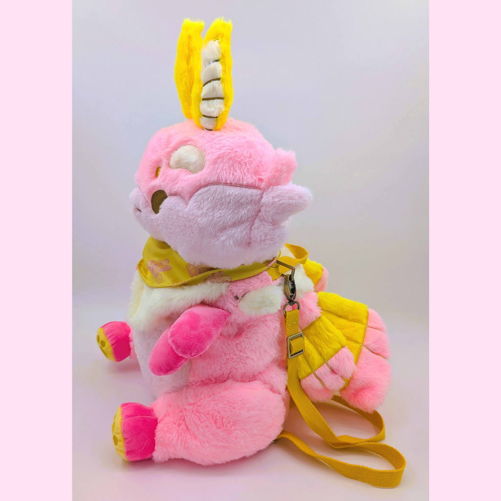 Side view of a plush backpack of a rosy maple moth