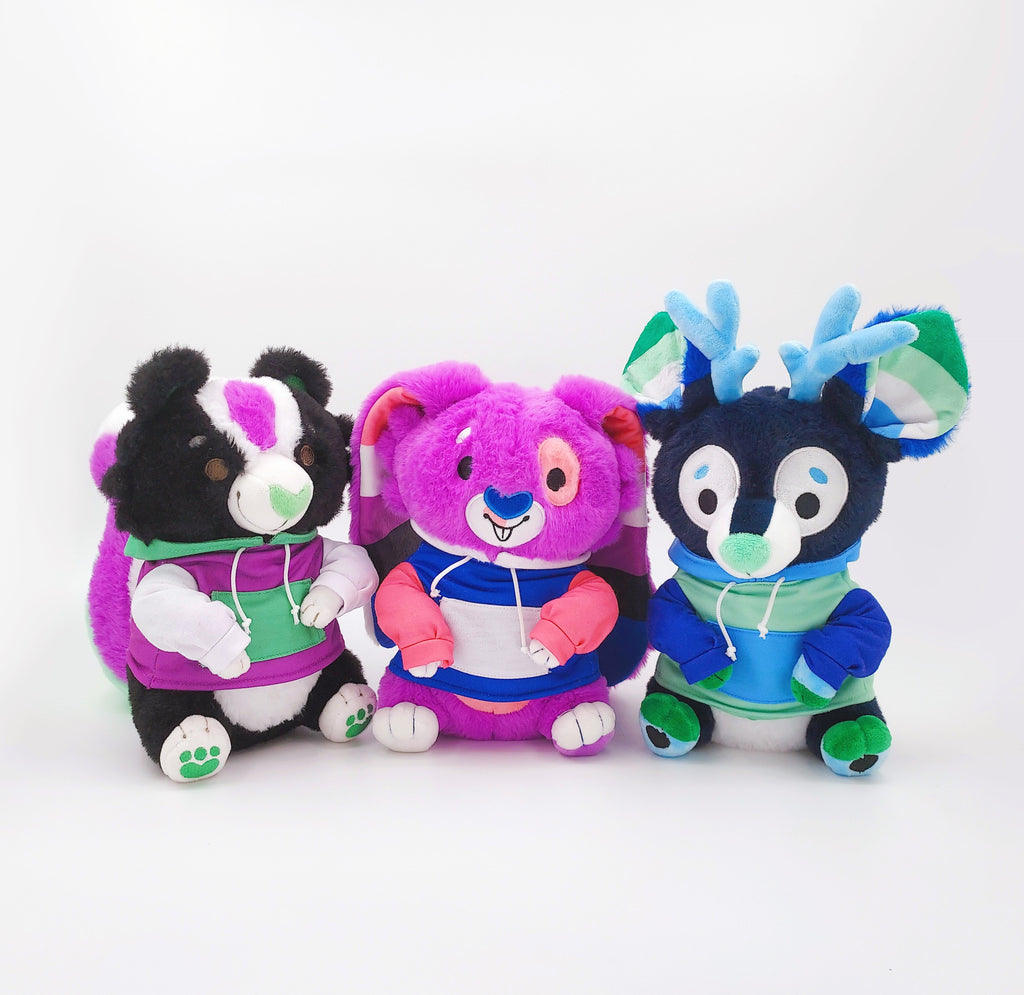 Plush of Pepper the skunk, Bubblegum the purple bunny, and Smoothie the blue stag