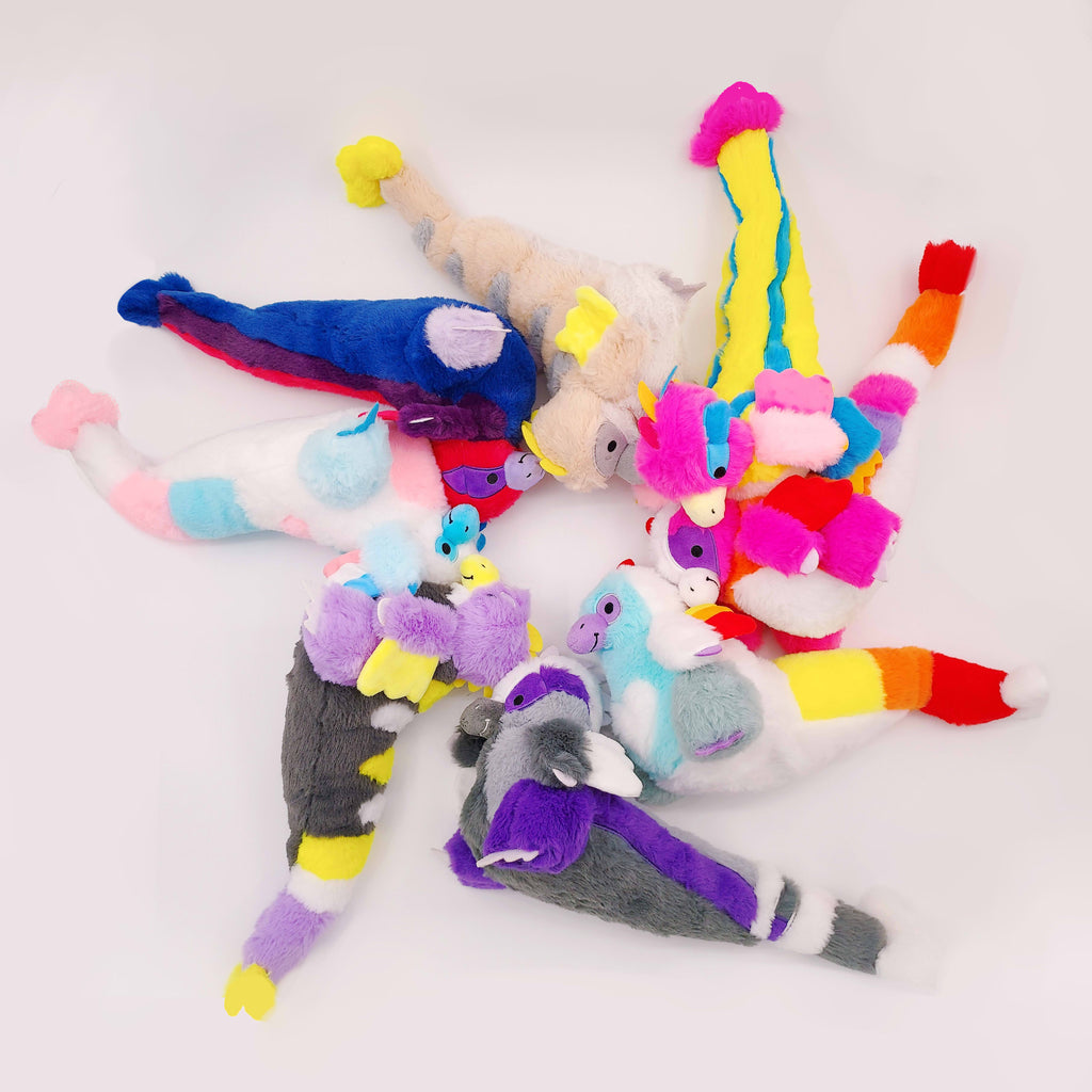 Eight plush toys of utahraptors laying in a circle, all in different multi-color patterns