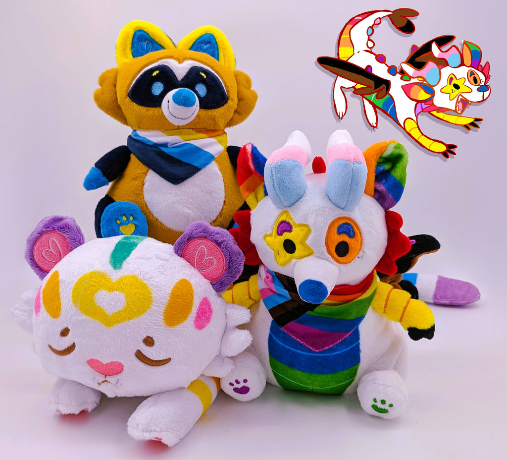 Plush toys of Mochi the Pastel Tiger, Mango the blue, orange, yellow raccoon and Mixtape the rainbow sparkledog dragon
