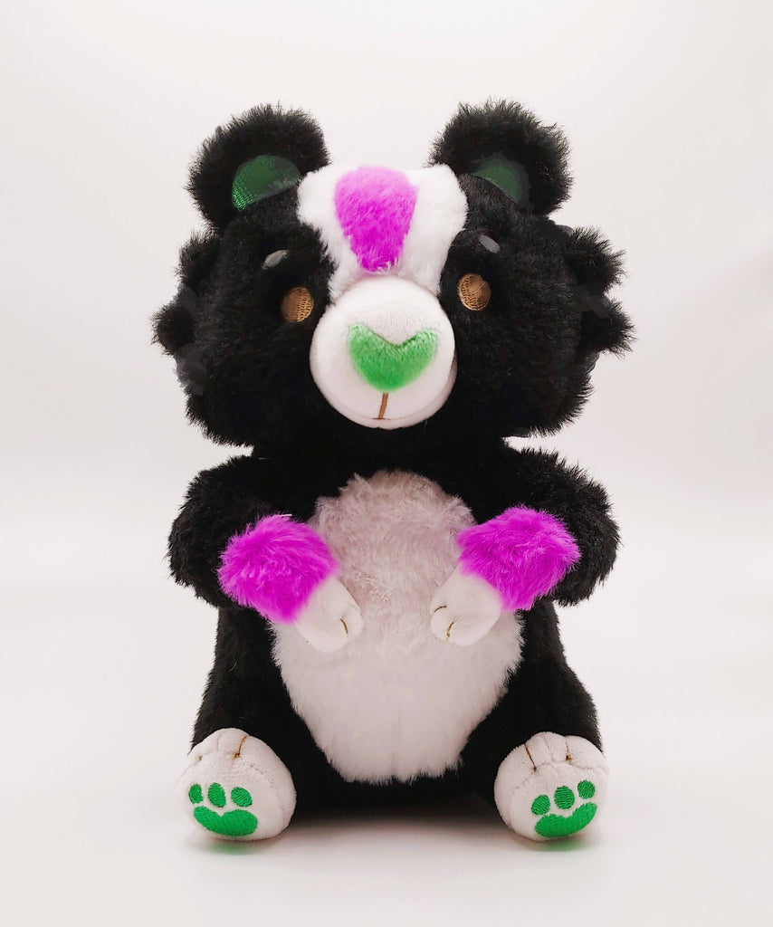 Plush toy of Pepper the green, purple, and white skunk