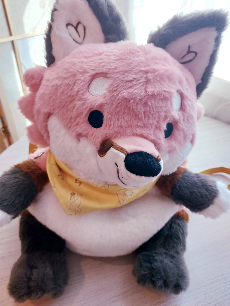 Plush backpack of Chiffon the fox in a selfie angle