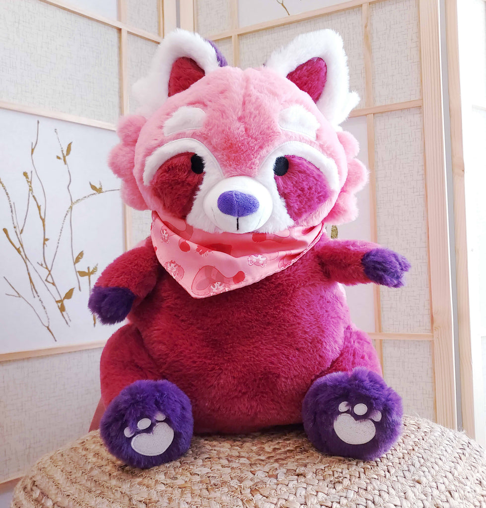 Plush backpack of Raspberry the red panda who is wearing a pink bandana