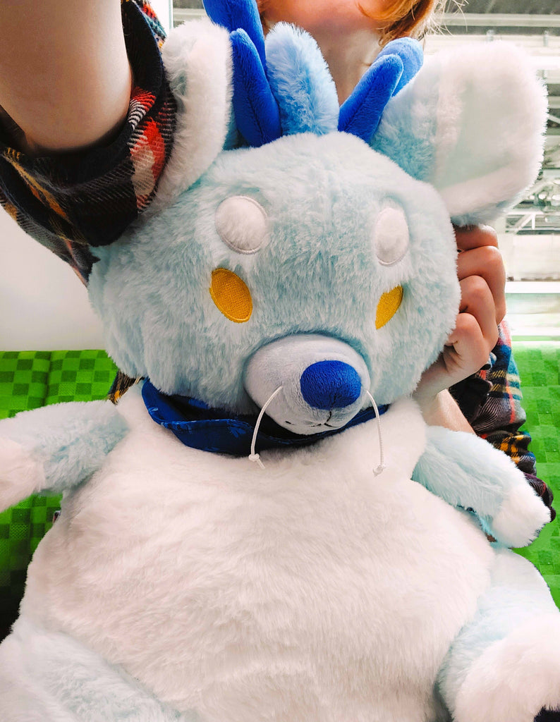 Plush backpack of Cloud the blue dragon in a selfie angle