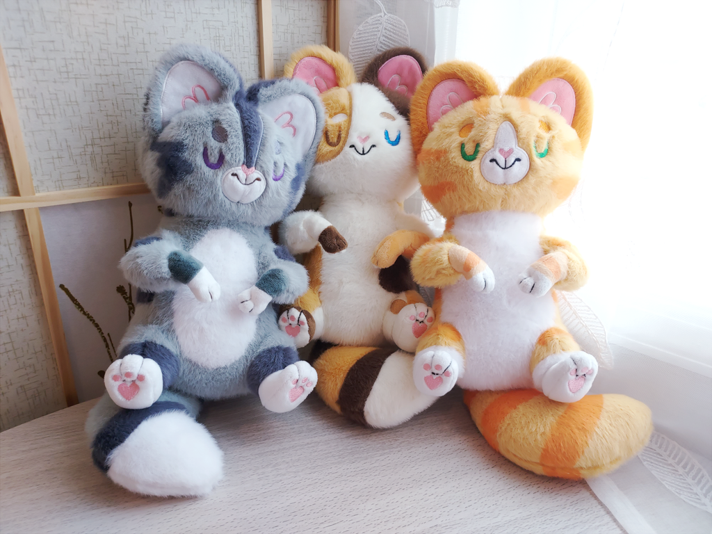 Snuggle Paws plush of Domino the grey Tabby, Doodle the calico cat, and Cheese the orange cat