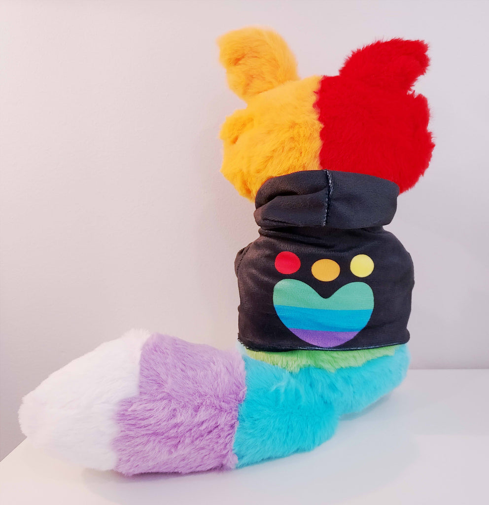 Back view of a plush toy of a rainbow border collie wearing a black hoodie with rainbow paw print logo