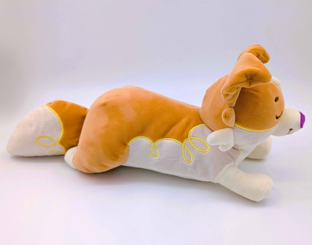 Side view of a laying plush toy of an orange border collie