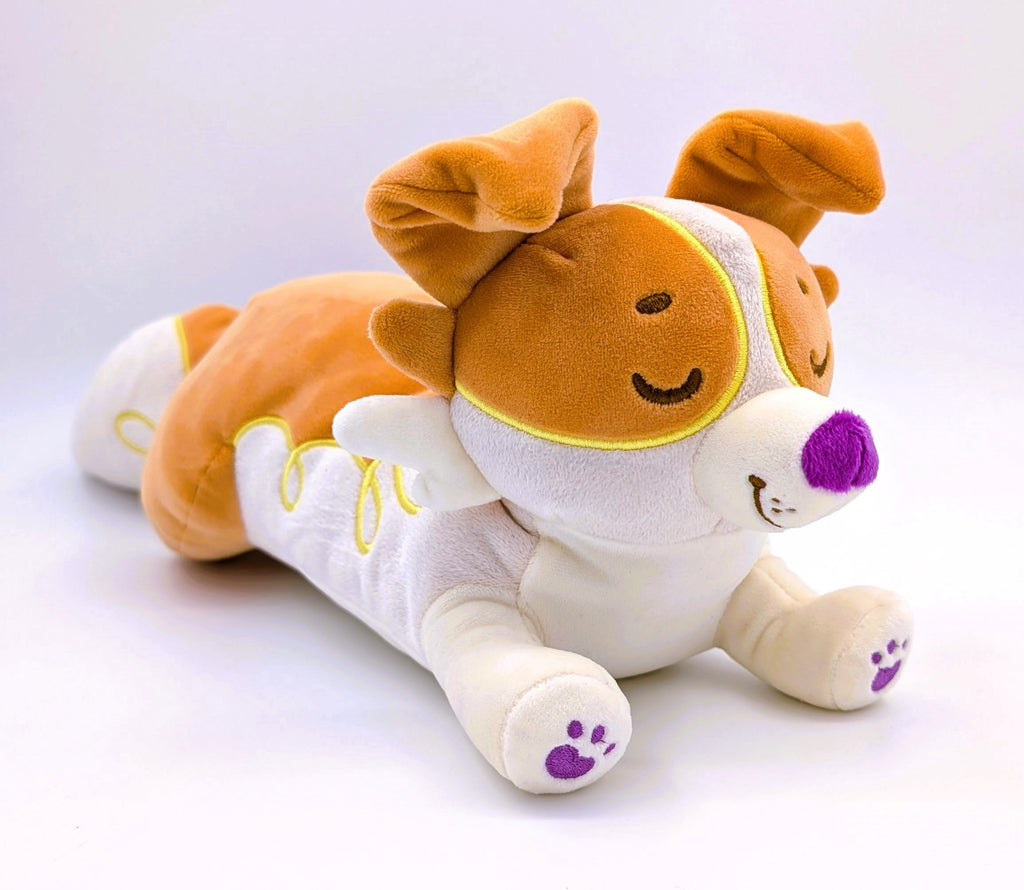 Laying plush toy of an orange border collie