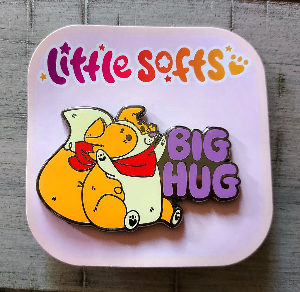 Enamel pin of Sunny Pup the red border collie that says "Big Hug"