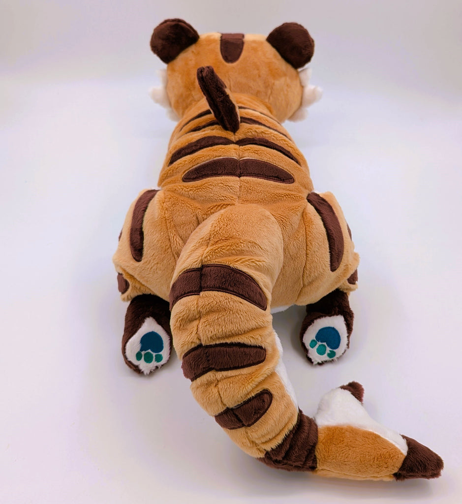 Back view of a plush of Cornflakes the Tiger and Shark hybrid