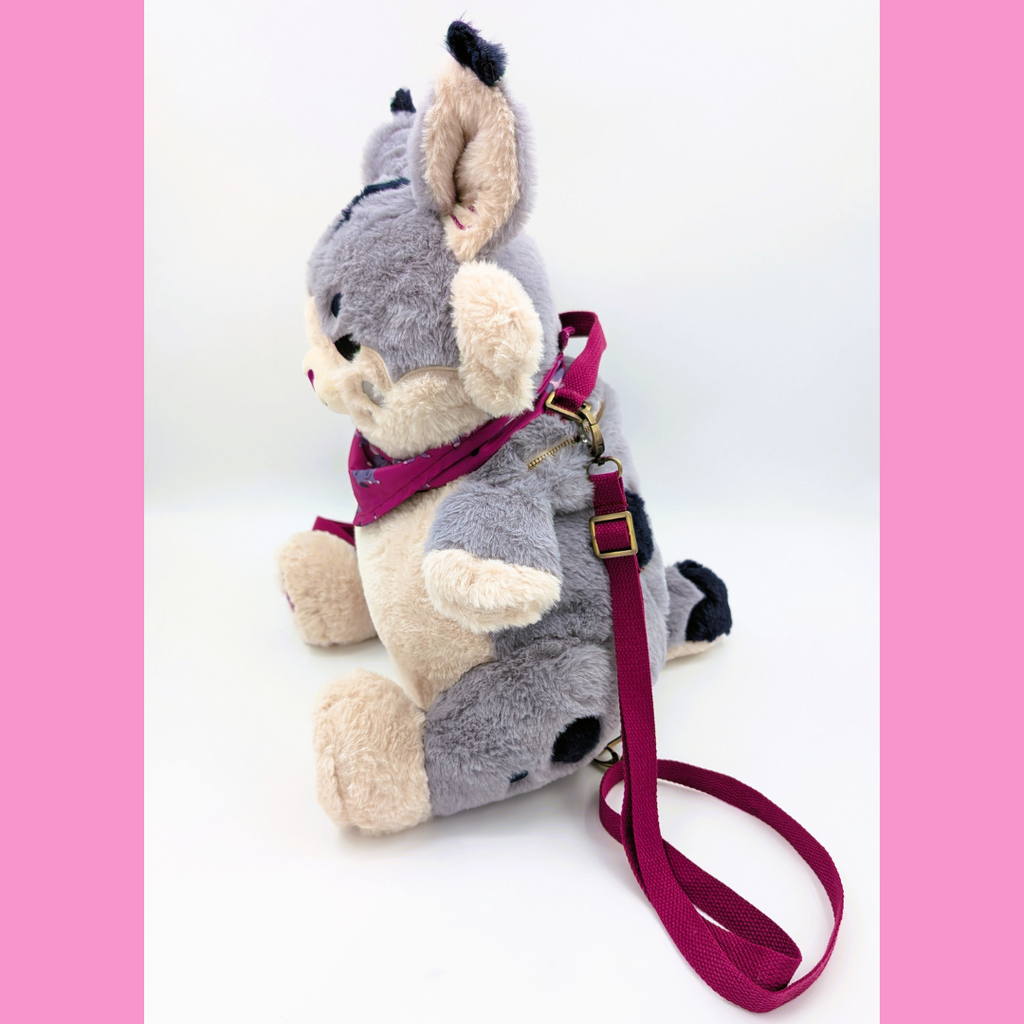 Side view of a plush backpack of a lynx