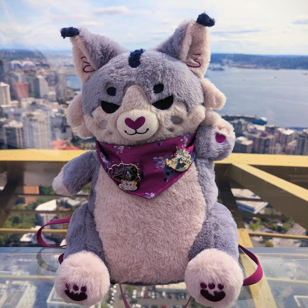 Plush backpack of a Lynx with a cityscape behind him