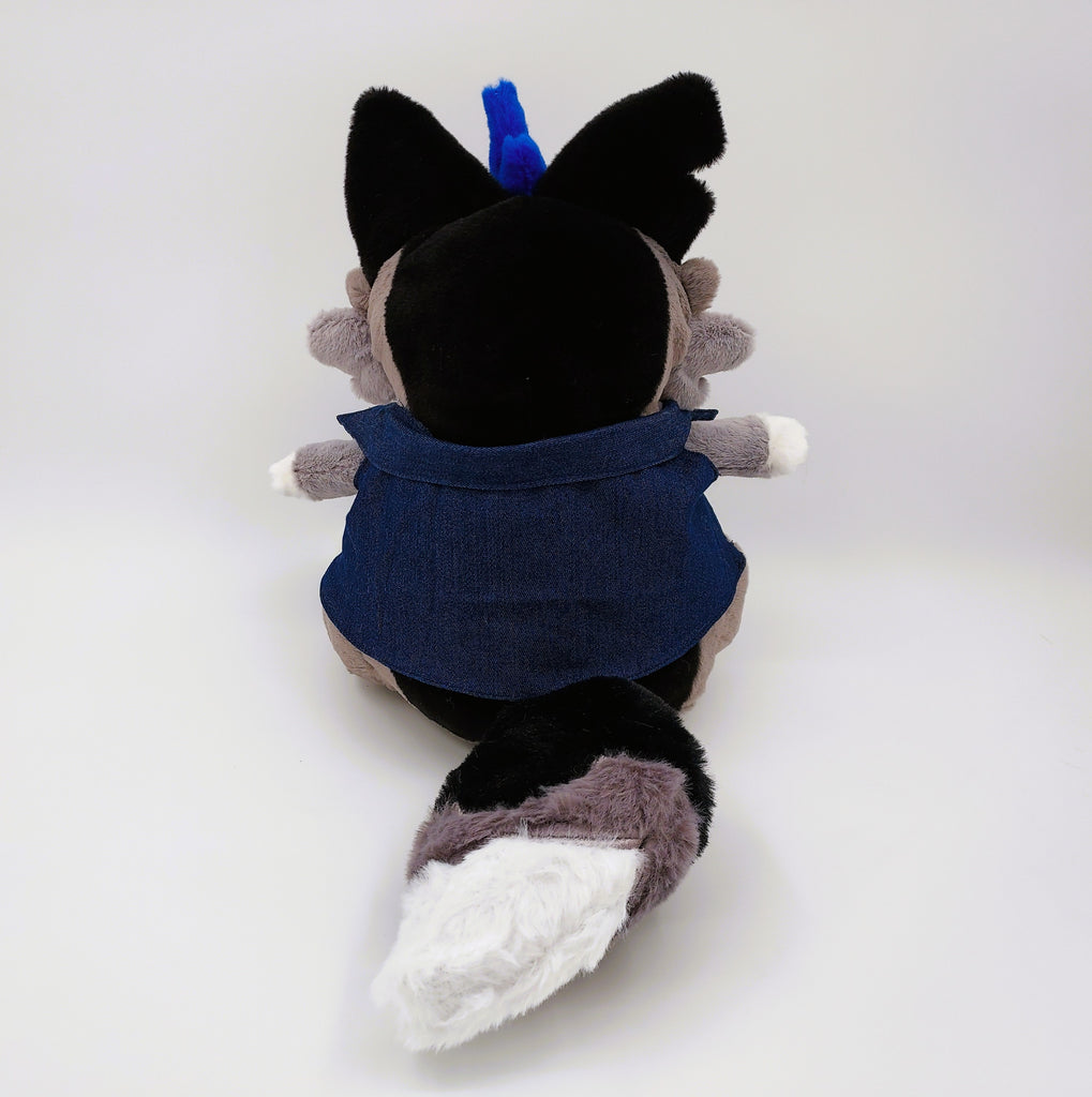 Back view of a plush toy of Wolfgang the werewolf with blue hair and a blue denim vest 