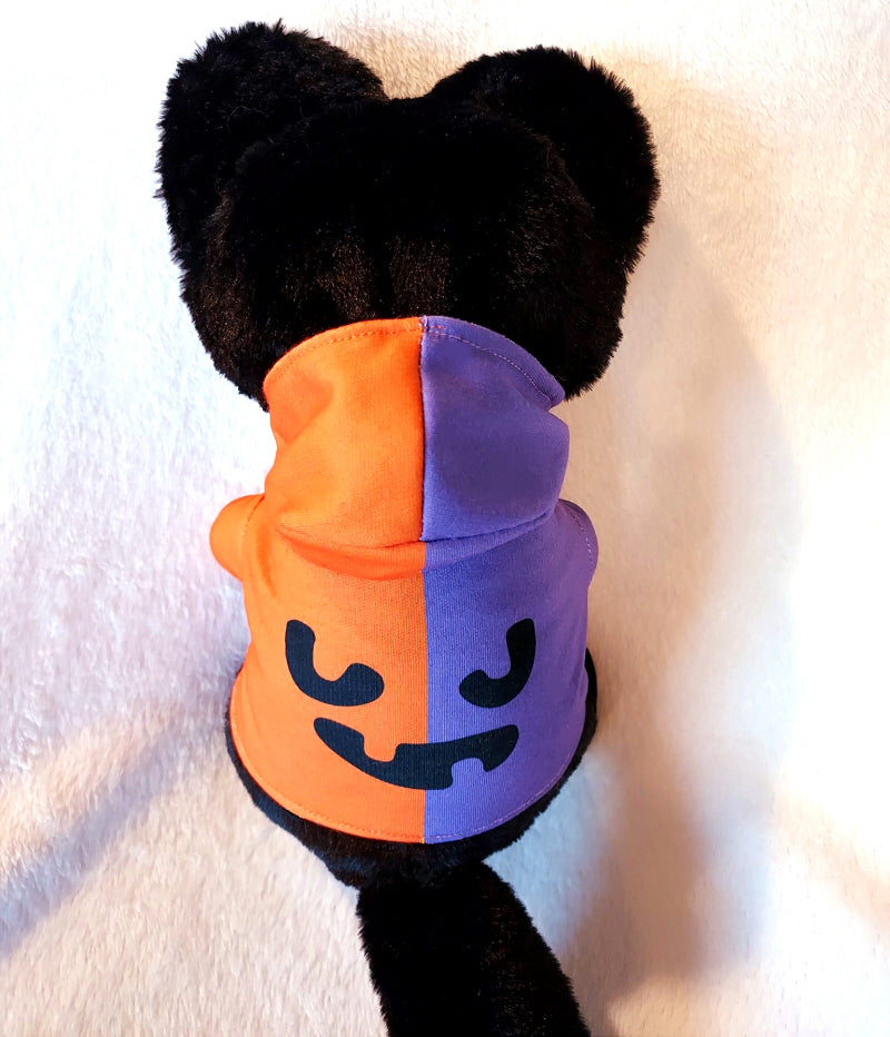 Back view of plush toy of Pumpkin Purr the black Halloween cat. She has purple and orange ears and a purple and orange hoodie