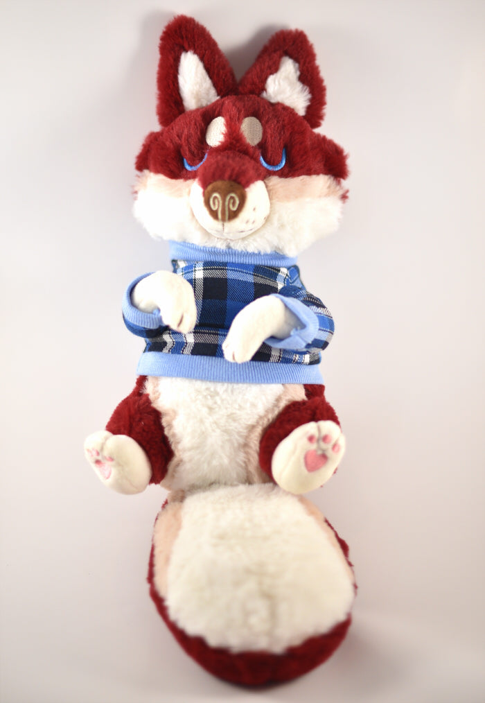 Plush toy of a red husky wearing a light and dark blue plaid sweater