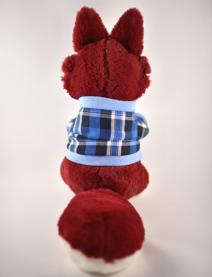 Back view of a plush toy of a red husky wearing a light and dark blue plaid sweater